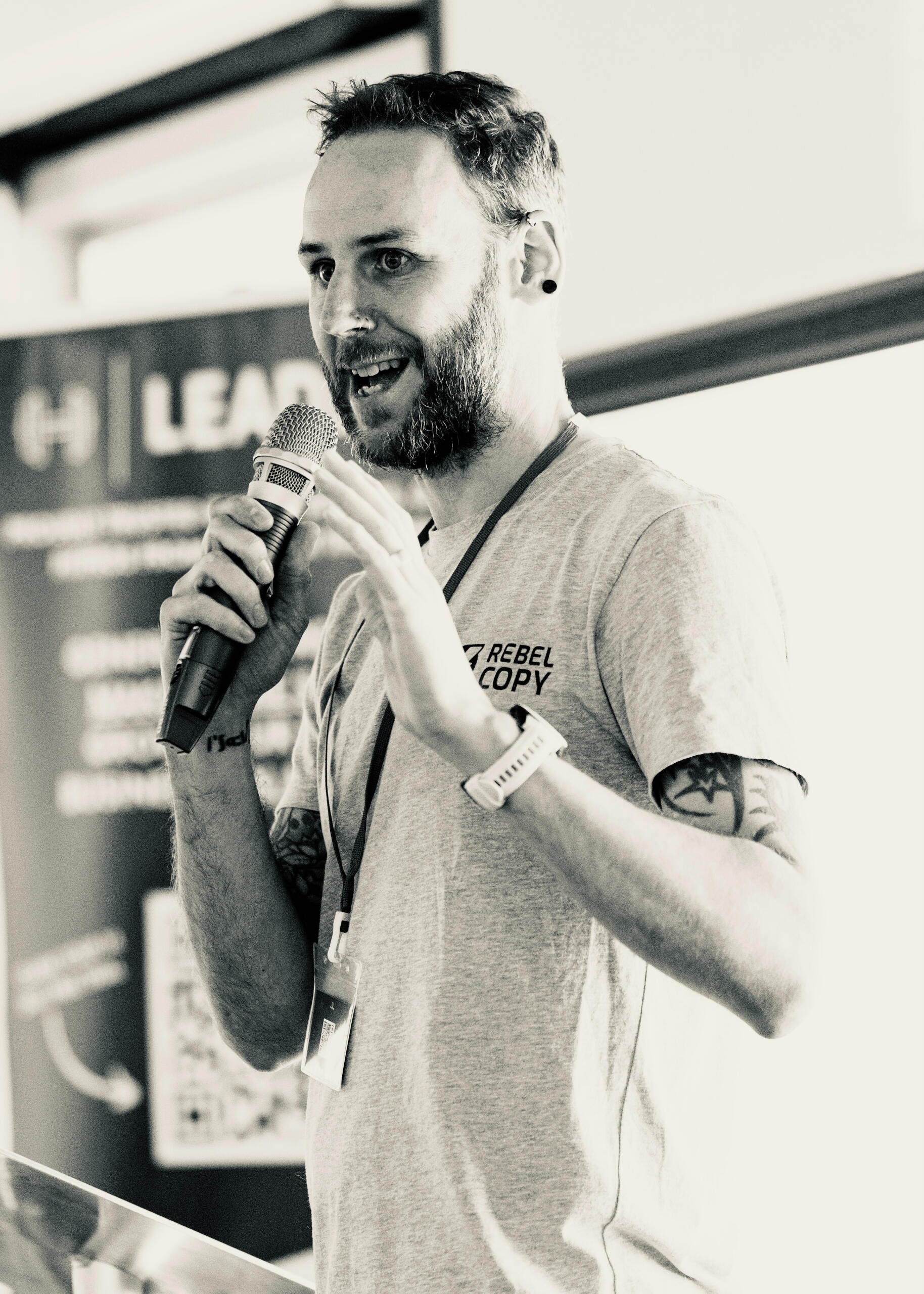 Al Clunnie (Rebel Copy) speaking on stage at a copywriting event